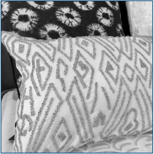 White cushion cover with silver beaded pattern