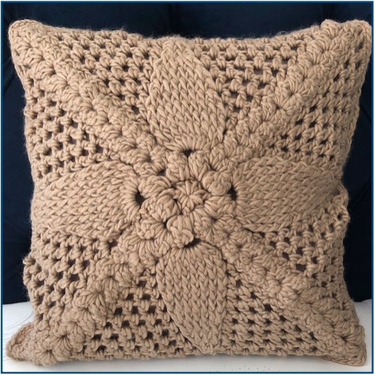 Brown crocheted flower cushion cover
