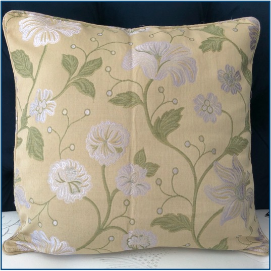 Pale green cushion cover with green and silver flower design